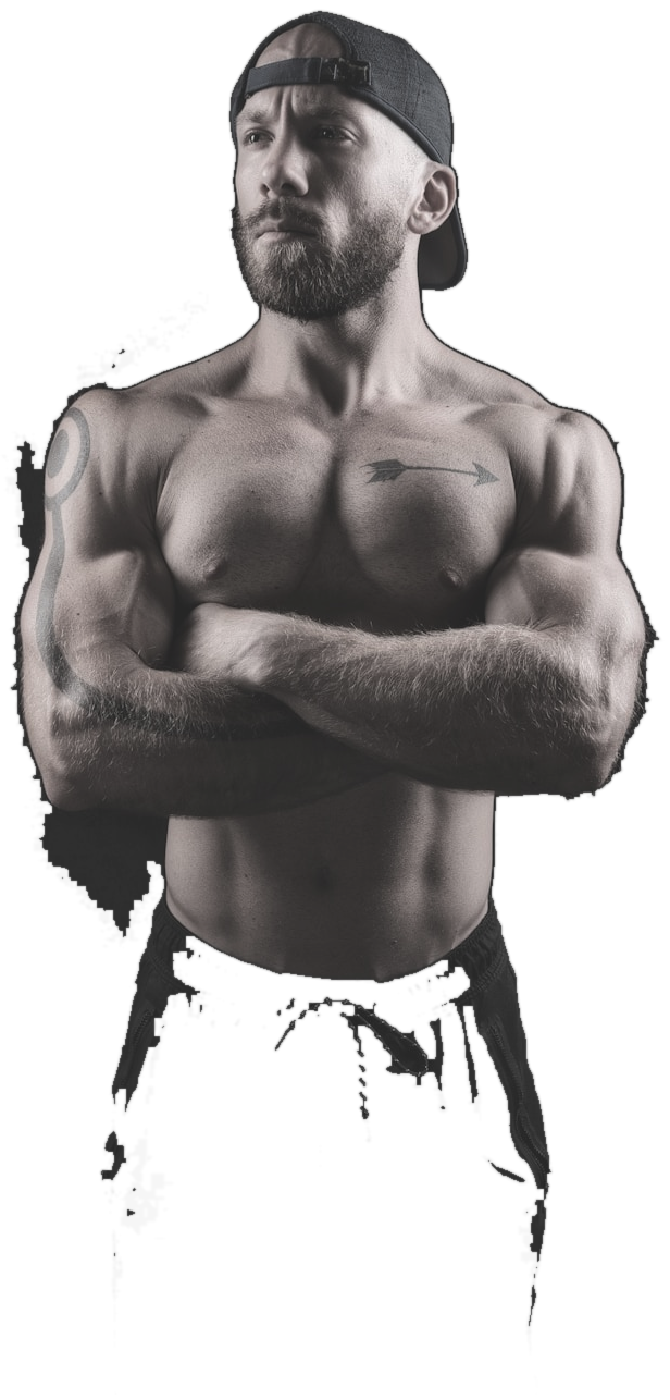 Athlete standing with arms crossed, lit against a dark studio backdrop