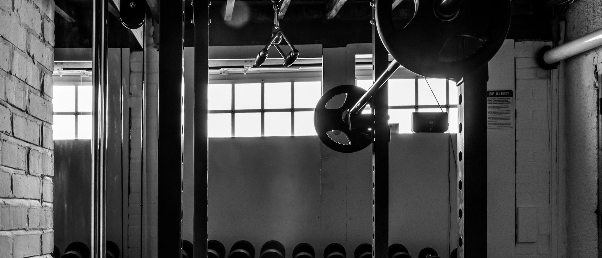 Squat racks and loaded barbells in the strength area
