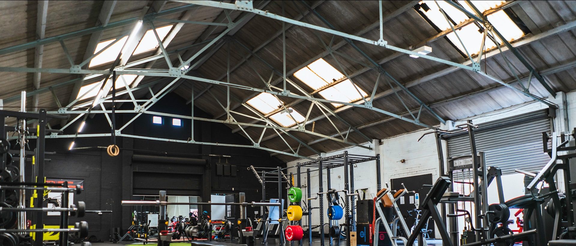 Wide view of the main training floor with racks and benches